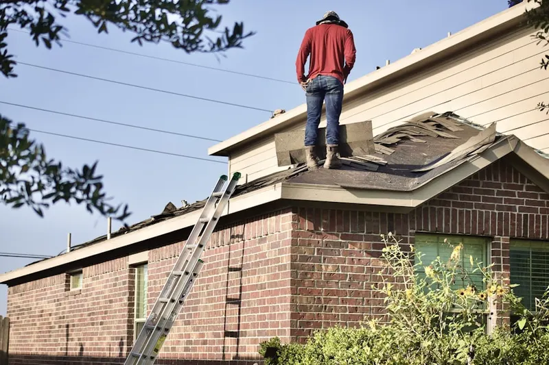 Professional roofer working on a residential roof in Brookhaven Estates